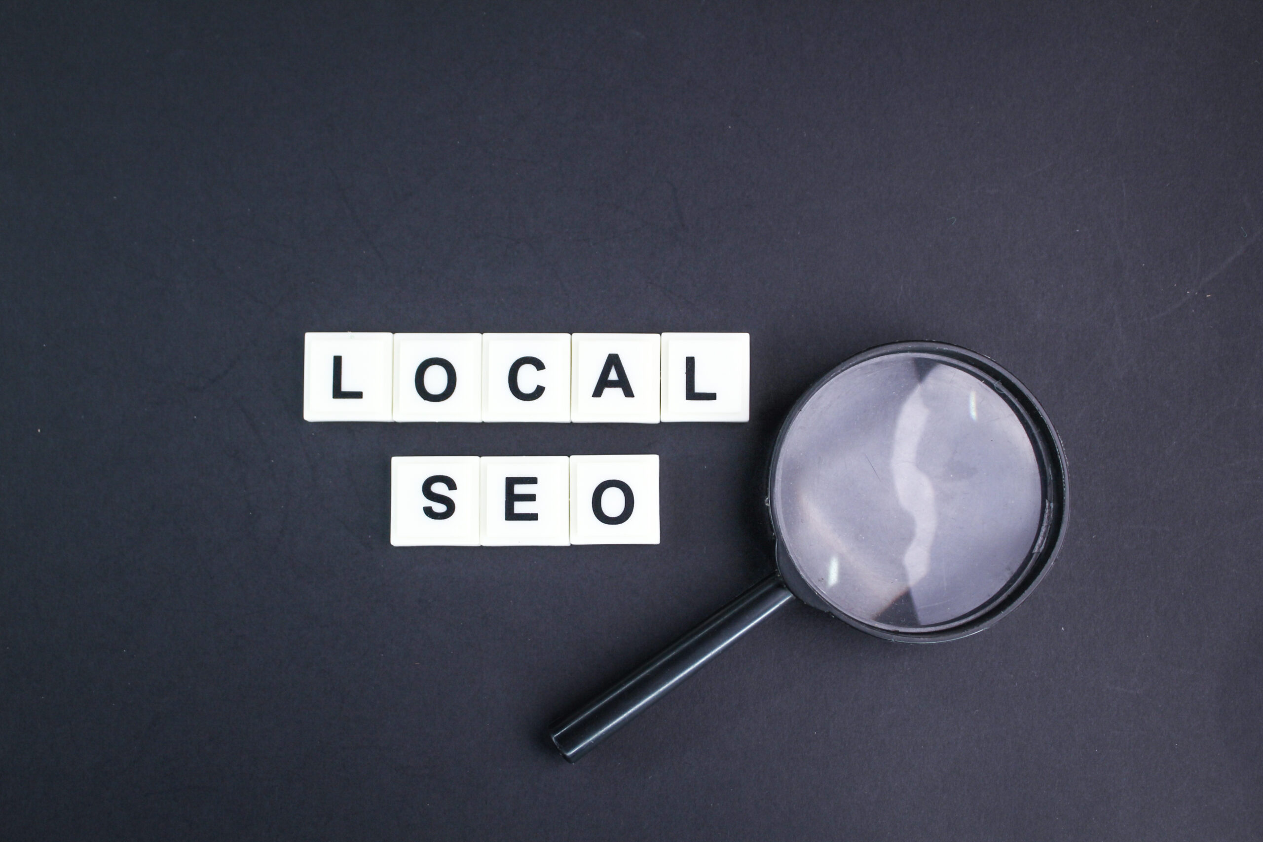 Magnifying glass with local SEO spelled in scrabble letters for Louisville digital marketing