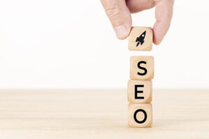 Blocks spelling out SEO with a rocket ship