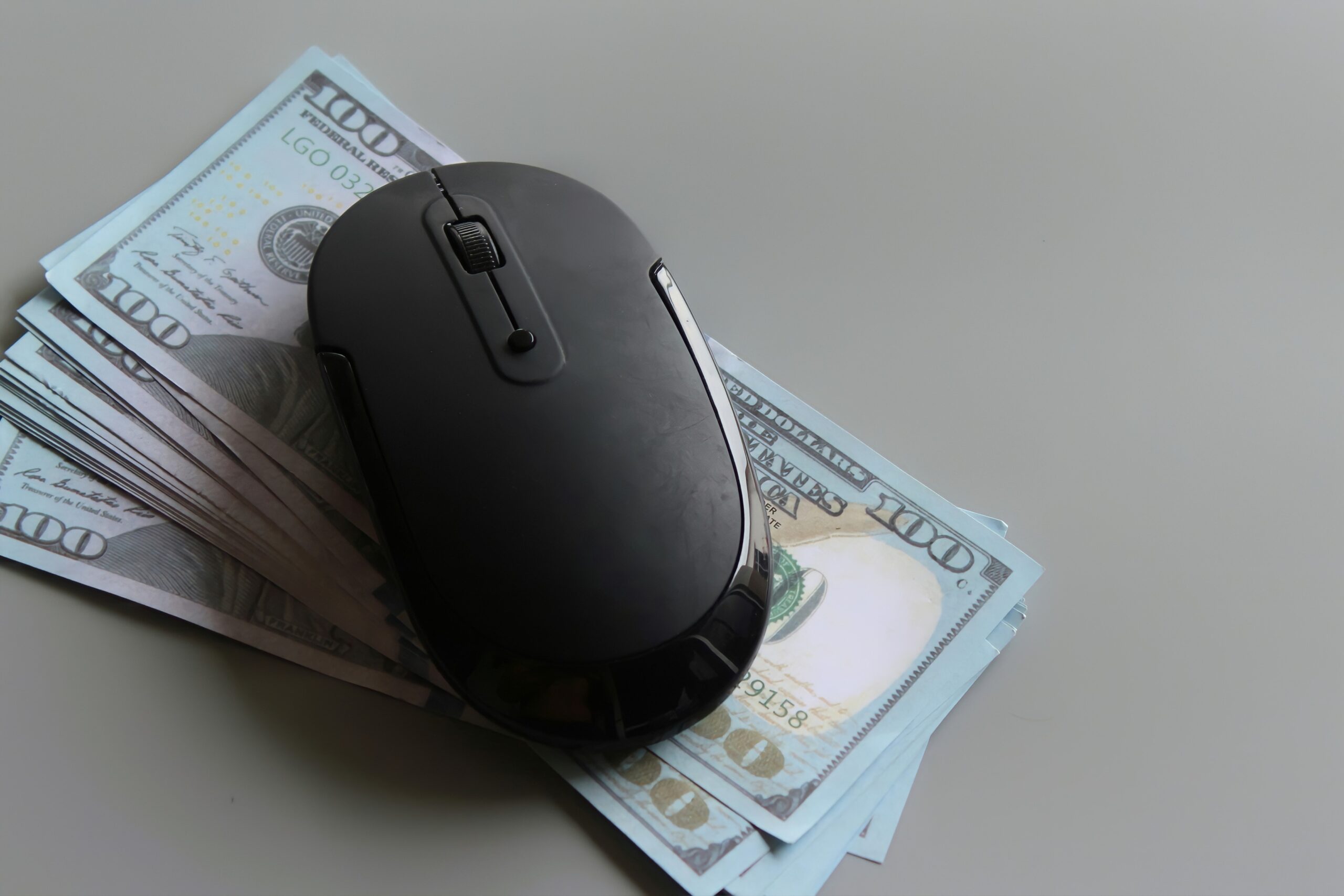 US dollar and computer mouse reflecting pay-per-click