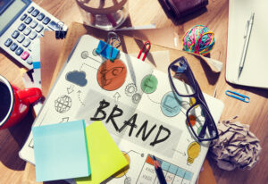 The word brand on paper surrounded by online branding components